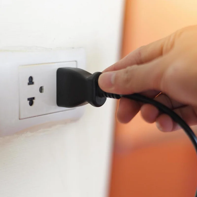 The Coolizi Coolzy mains plug entering a wall socket