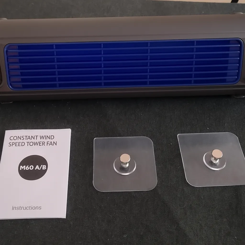 The instruction sheet the seller photographed, headed &ldquo;Constant Wind Speed Tower Fan, M60 A/B&rdquo;, beside the two adhesive mounts