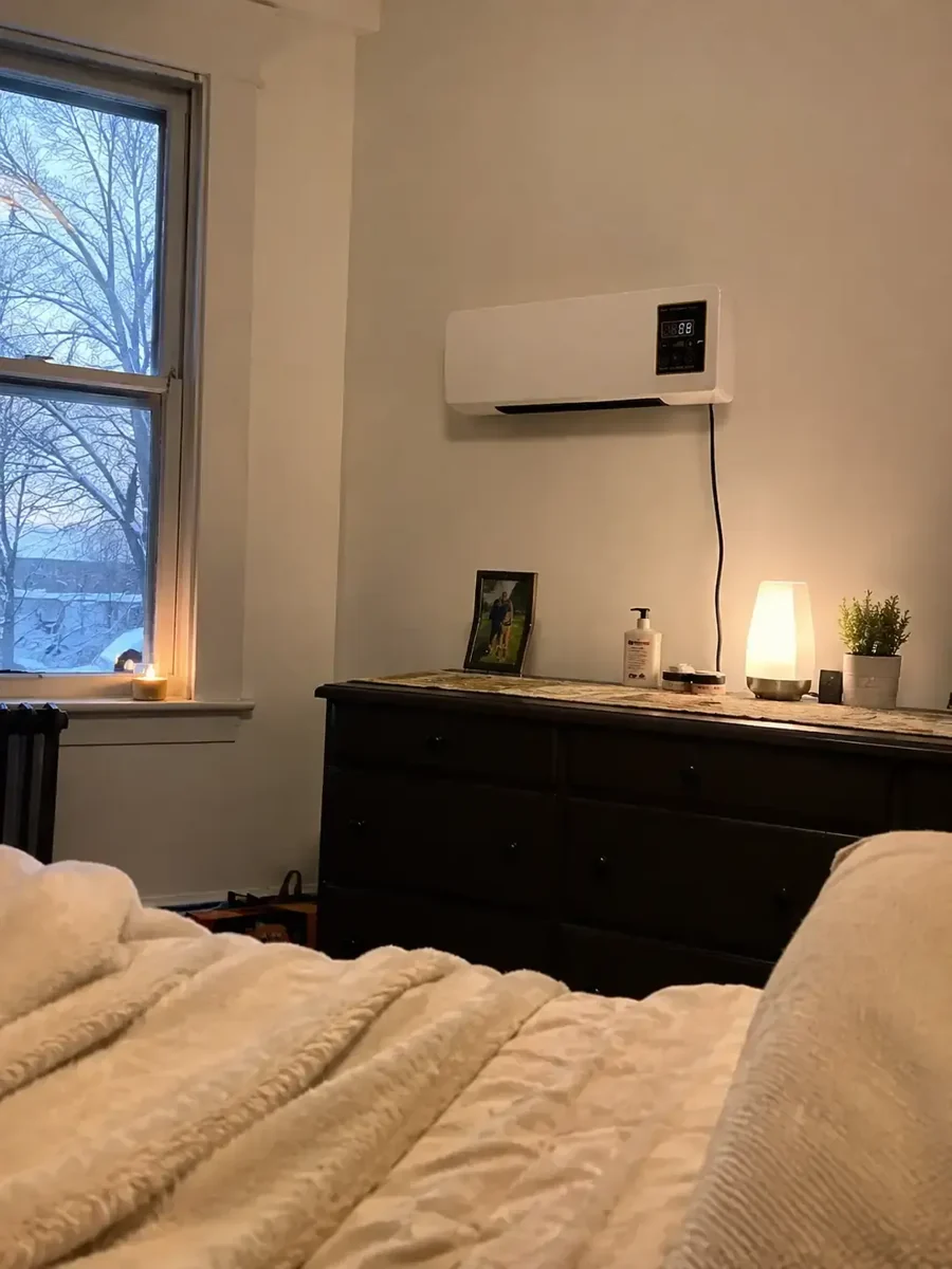 Vital Pro Breeze mounted on a bedroom wall above a chest of drawers